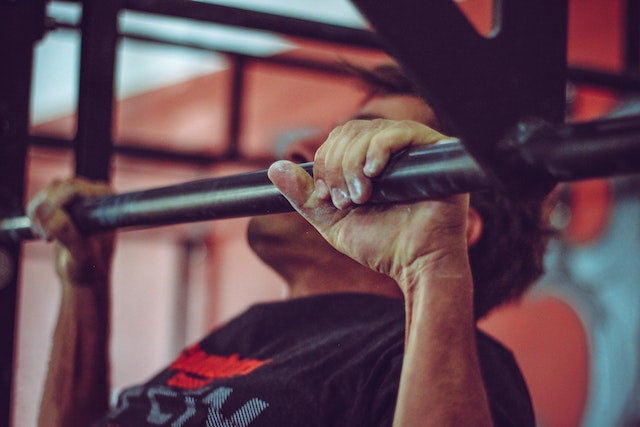 Man in a black shirt doing pull-ups